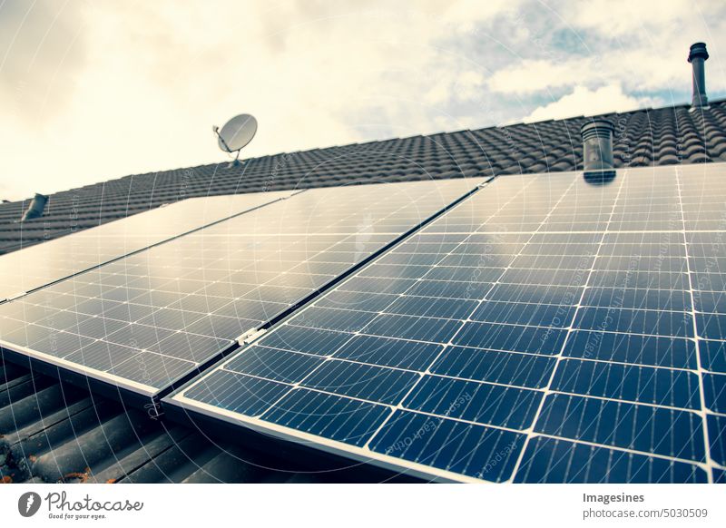 Balcony power plant. Solar panels on the roof. Close up of solar power plant on cloudy sky. solar collectors Roof Close-up Solar system Sky bad Weather