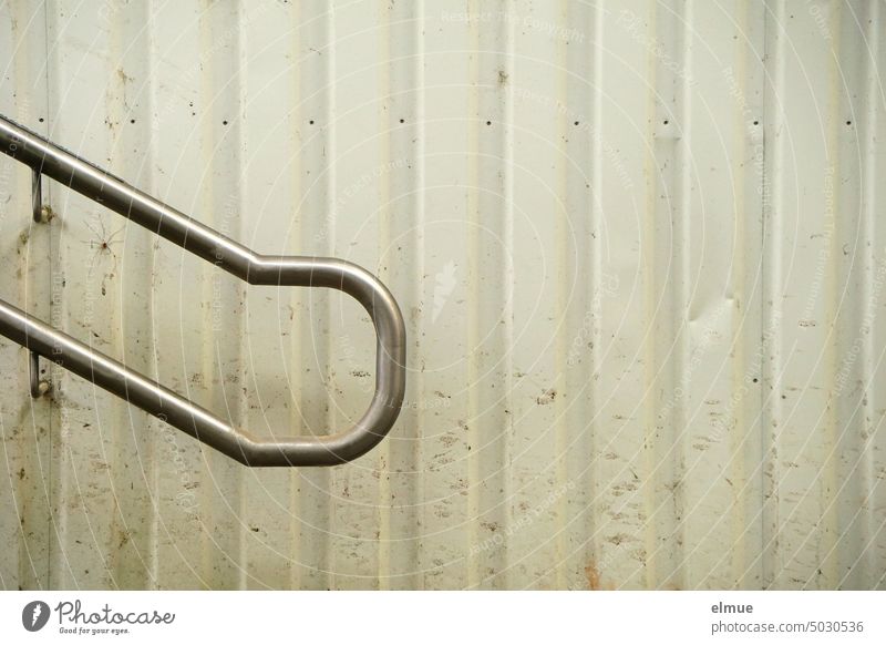 End of a handrail on the gray sheet metal wall of an underpass with a lot of dirt and a weaver crawler Underpass Metal daddy-long-legs spirit filth Mowers