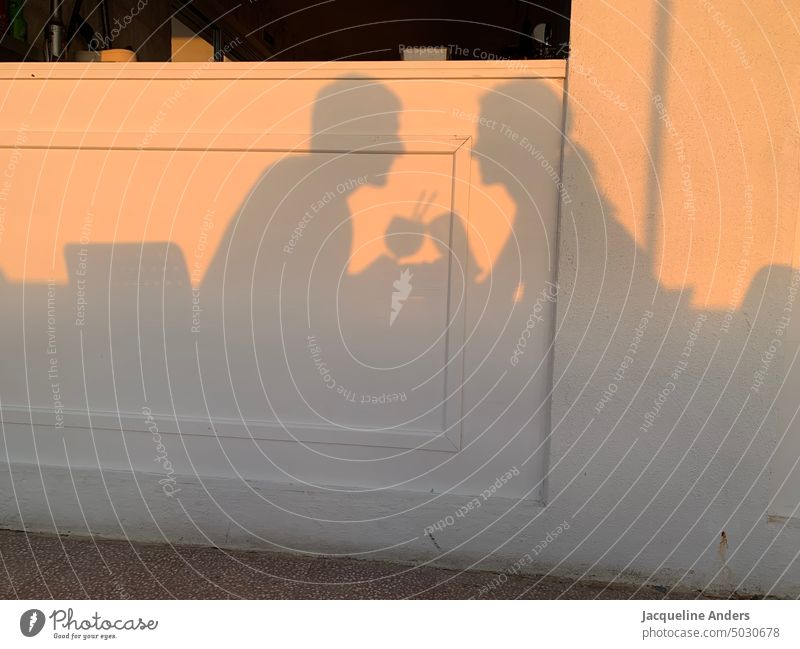 Shadow of couple toasting each other with two cocktail glasses Shadow play Cheers Couple Toast Glasses drink Cocktails Silhouette Sunlight Light and shadow