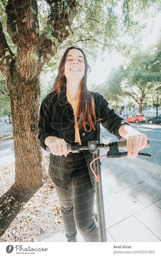 Happy smiling female friends having fun on electric scooter in the city, Generation Z modern life person riding technology woman adult lifestyle outdoors