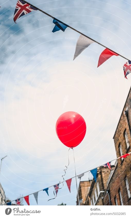 Not amused - party mood Balloon Paper chain Union Jack London Building street photography Exterior shot Great Britain England Colour photo Blue City Sky