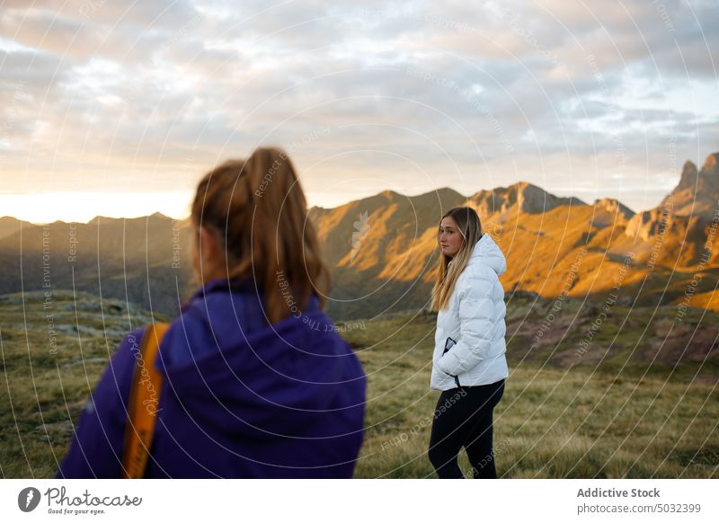 Women against mountains and sundown sky women sunset valley together girlfriend weekend evening countryside ridge female young twilight nature relationship love