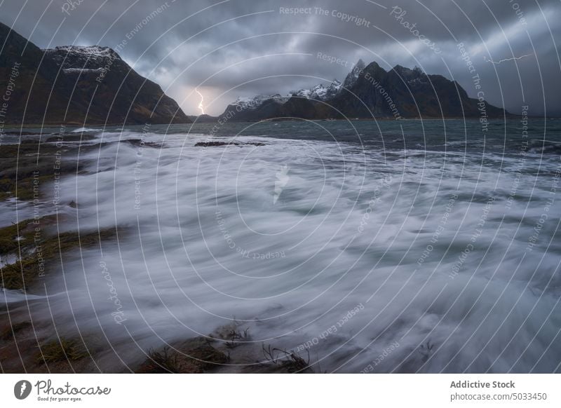 Lightning flashing above stormy sea on cloudy day mountain lightning thunderstorm landscape sky dramatic scenic ocean nature energy picturesque weather marine