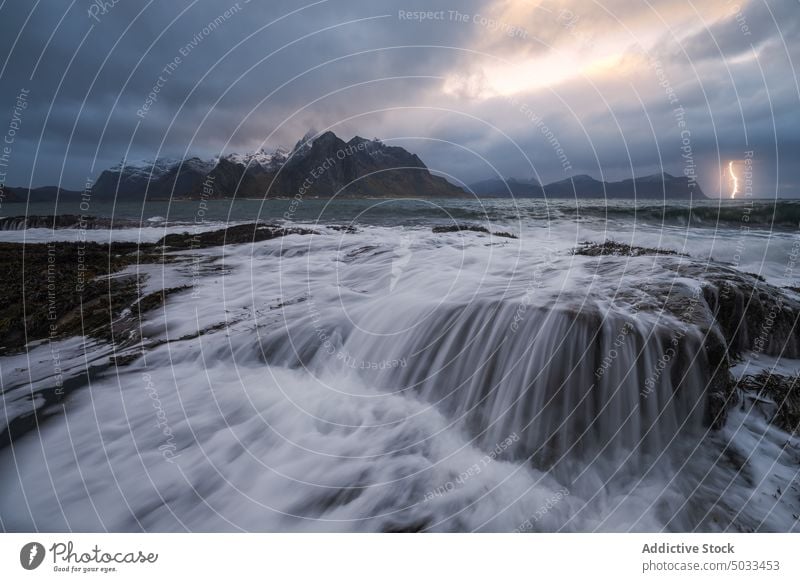 Lightning flashing above stormy sea on cloudy day mountain lightning thunderstorm landscape sky dramatic scenic ocean nature energy picturesque weather marine