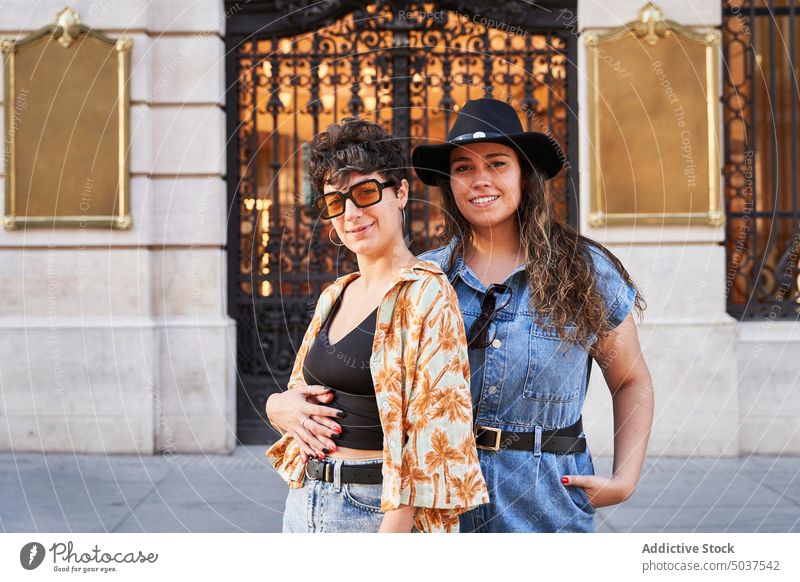 Stylish girlfriend against historic building couple women hug street tourist style lesbian relationship madrid spain female young love gate smile lgbt romantic