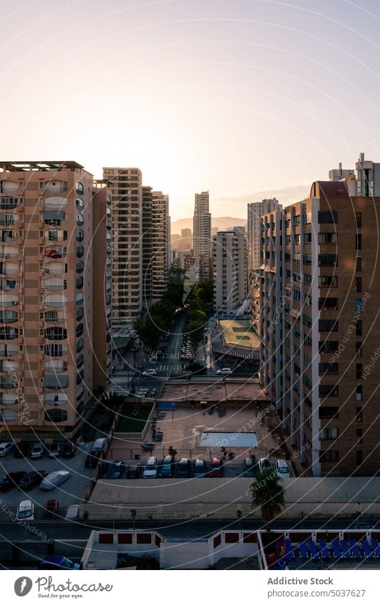 Residential buildings against sunset sky apartment street city modern district architecture urban cityscape twilight dusk sundown construction structure dwell