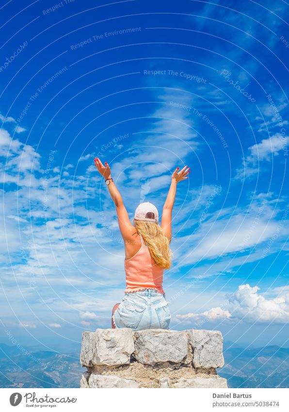 Young girl sitting on a stone with a beautiful view from the top of Mont Ventoux aerial altitude arid background building desert dry france geology