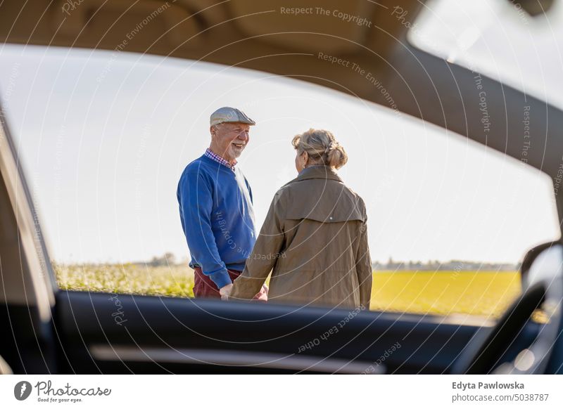 Senior couple on a road trip journey transportation car auto travel adventure holiday senior couple woman two people mature together old retired sunset joy love