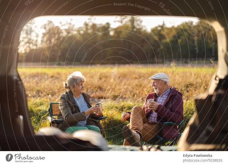 Senior couple on a road trip journey transportation car auto travel adventure holiday senior couple woman two people mature together old retired sunset joy love