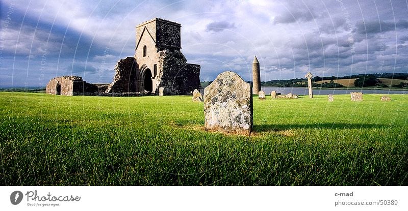 Ruin on Derwenish Island Northern Ireland Manmade structures Celts Cemetery Grave Clouds Summer Evening sun Green Gray Wide angle River Tower Construction site