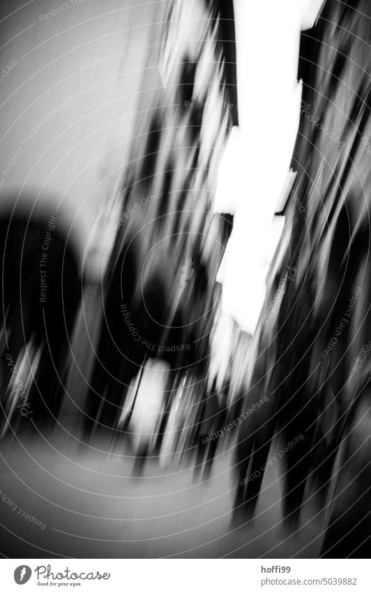 blurred view of crooked alley or pedestrian street with people and houses hazy Abstract blurriness Light urban Mysterious depression Fear anxiety Ambiguous