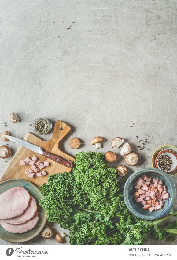 Kale cooking background with fresh kale leaves, smoked pork meat and mushrooms , top view, frame above fillet food green ingredient meal spicy table