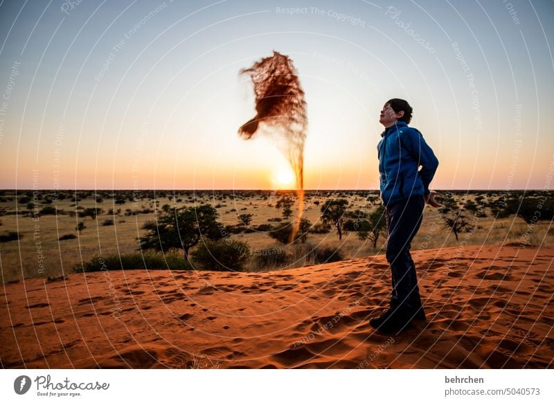 sand painting Tracks Joy Playing fortunate cheerful balanced Infancy Child Boy (child) Kalahari desert Sky wide Sunlight beautifully Twilight Fantastic Hope