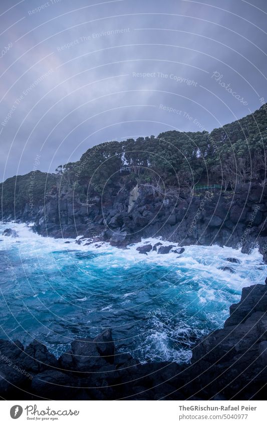 Wild sea with rocky coast Cliff Water Waves salt water Bad weather Ocean Exterior shot Landscape Blue sky Sky Rock Vacation & Travel Azores travel Nature