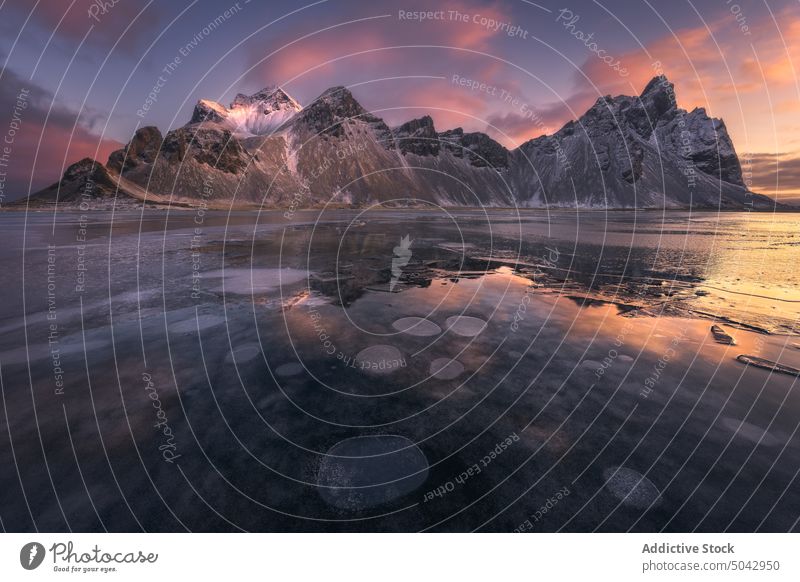 Snowy mountains near frozen lake landscape nordic scenery spectacular Iceland snow Stockness nature sunset range sky Vestrahorn beach evening winter calm