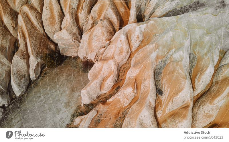 Rough rocky formations under cloudy blue sky in sunlight nature volcanic valley geology landscape highland hoodoo ridge mountain scenic cappadocia turkey