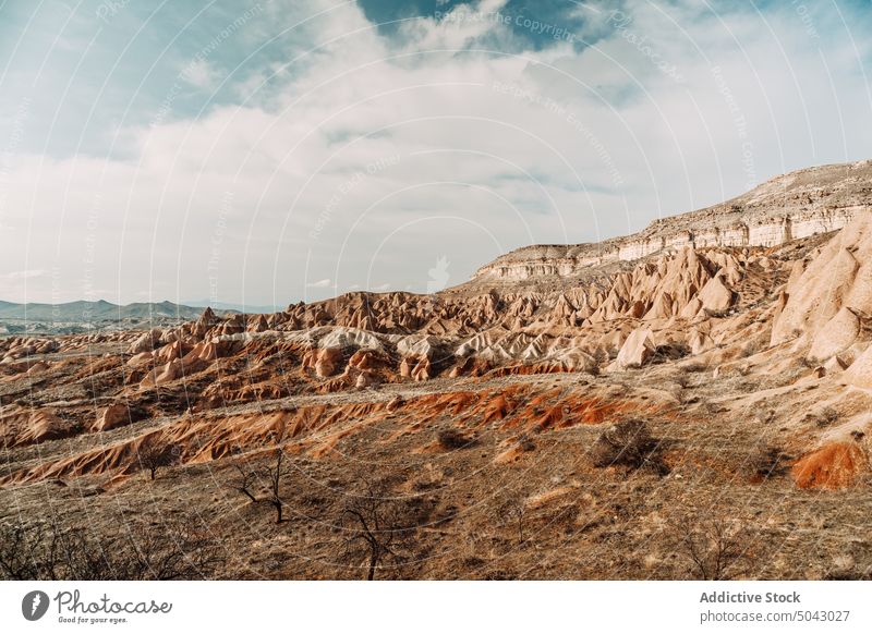 Scenic landscape of rough rocky mountains under cloudy sky valley nature breathtaking formation highland geology ridge picturesque range scenery observe