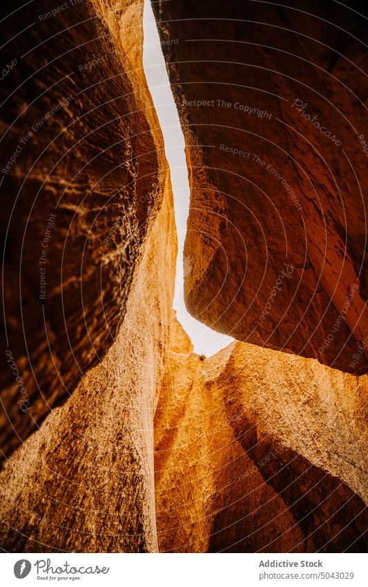 Rocky formations in canyon on sunny day cave rocky nature volcanic sandstone cliff geology uneven rough massive picturesque scenic sunlight cappadocia turkey