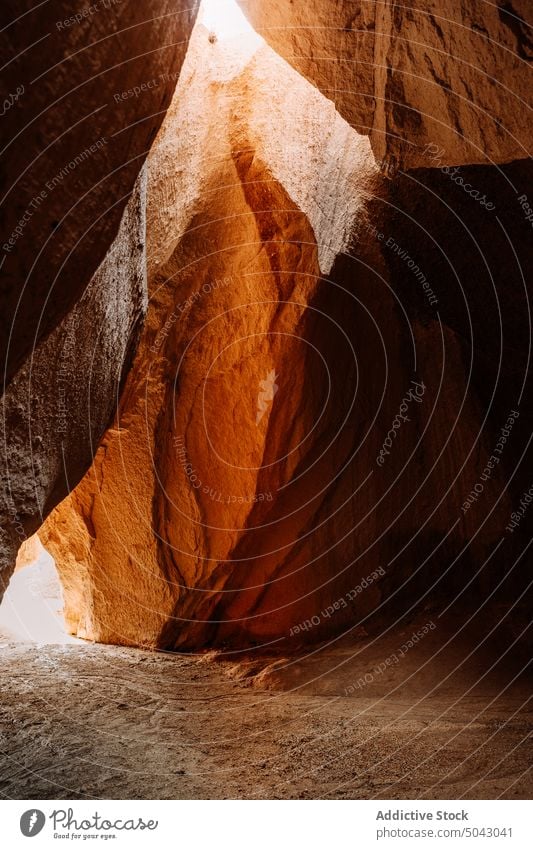 Rocky formations in canyon on sunny day cave rocky nature volcanic sandstone cliff geology uneven rough massive picturesque scenic sunlight cappadocia turkey