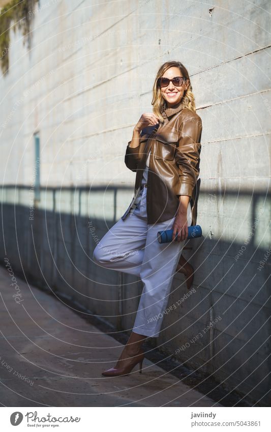 Middle aged woman with sunglasses taken a coffee break carrying an eco-friendly thermos for coffee middle aged bottle beautiful urban outdoor style fashion