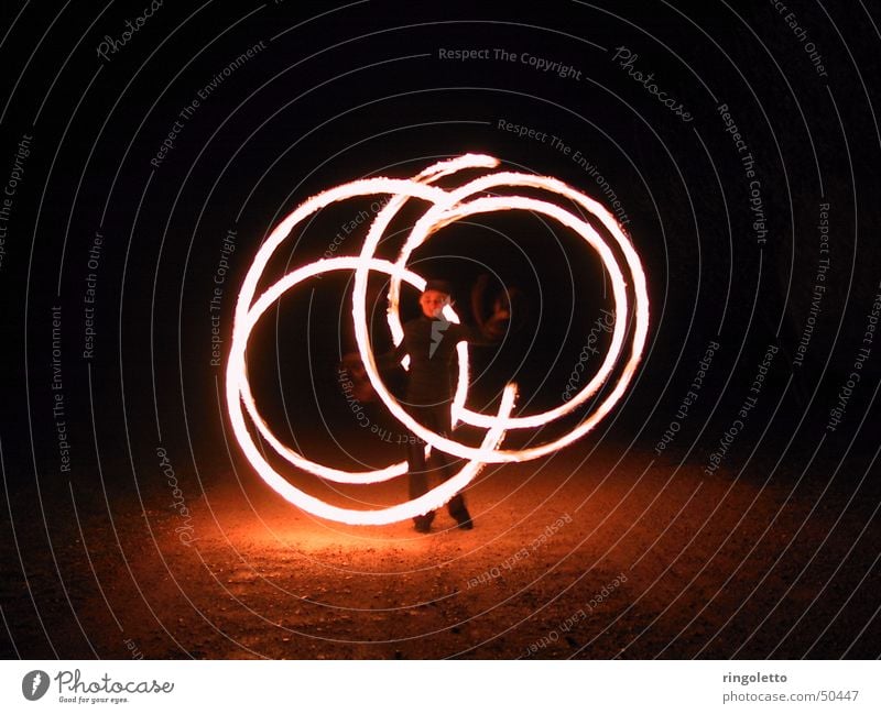 In the circle of fire Juggle Night Acrobatics Shows Romance Art Round Fiery Exterior shot Night shot Blaze Bright artistic Tasty Artist Elegant