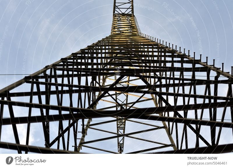 No bouldering here! Steel lattice tower for high-voltage line for power transmission on a power line from below and very close. Overhead line mast