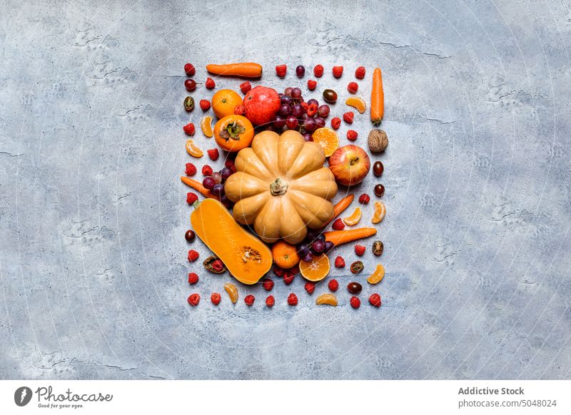 Raw pumpkins and assorted autumn veggies vegetable fall still life apple persimmon harvest fresh food raw dark background healthy natural various colorful