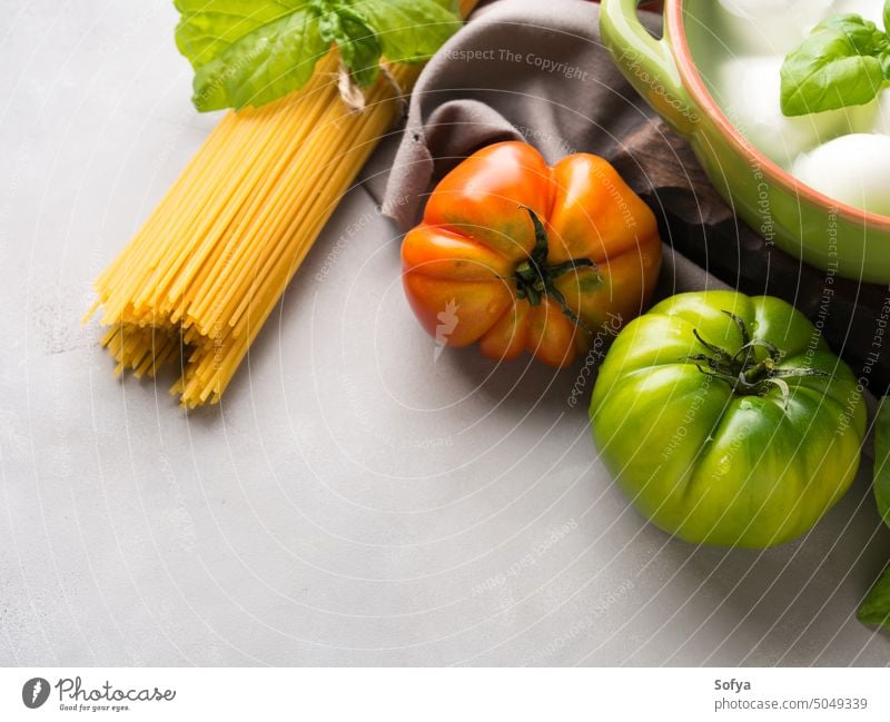 Italian food tomato mozzarella still life italian cuisine cheese cook uncooked caprese salad pasta spaghetti sauce local gray rustic wooden board eat gourmet