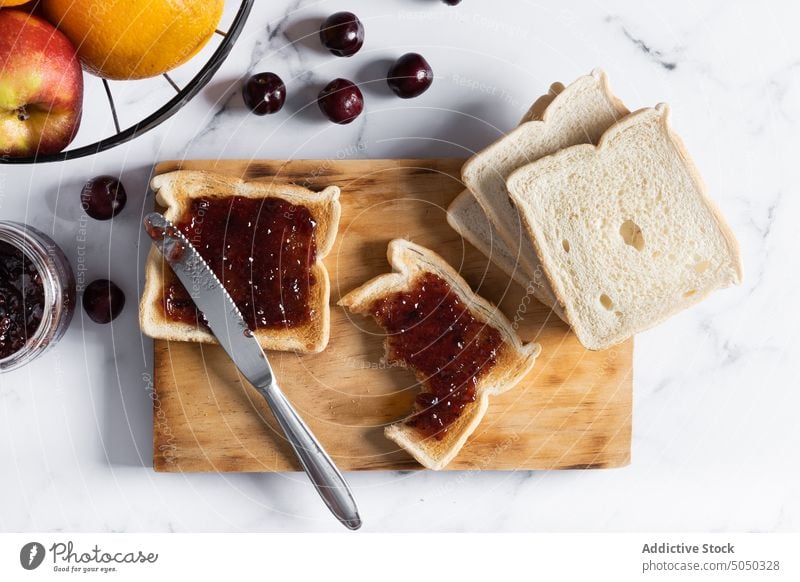 Delicious toasts with jam on cutting board food breakfast delicious berry cherry sweet knife yummy fresh tasty serve appetizing ripe healthy crispy morning