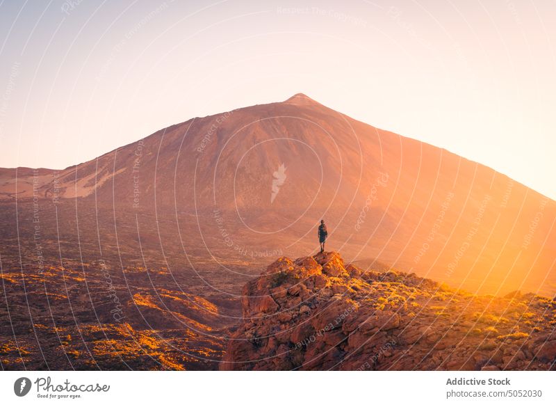 Small silhouette of traveler against huge volcano landscape scenery mountain spain tenerife canary islands rocky tourist contrast edge nature majestic tourism