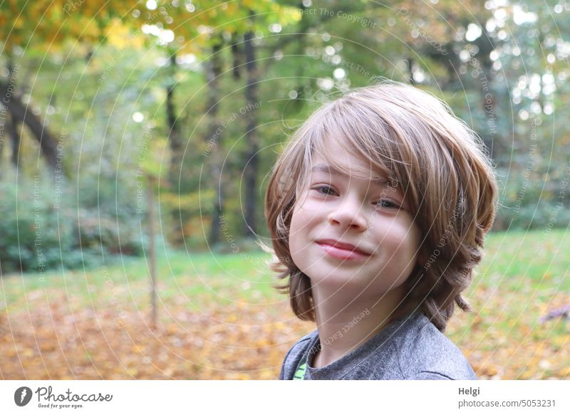 Portrait of smiling boy in nature Human being Child Boy (child) portrait Infancy Head hair Smiling out Nature Close-up Hair and hairstyles Face Colour photo