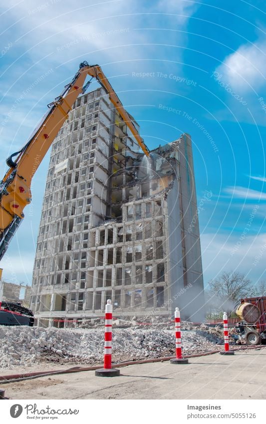 Demolition of the old building with sloopkraan. Residential building, high-rise building on the construction site. Inner city demolition of the high-rise building in Mainz, Germany.