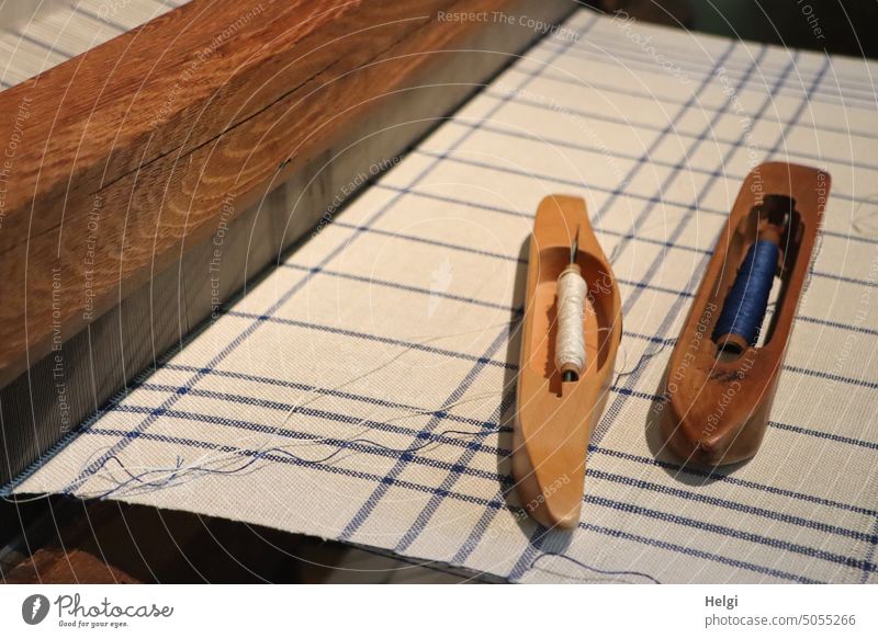 Shuttles and bobbins on freshly woven fabric on a historical loom Loom Weaving equipment Old Historic Museum Craft (trade) Flat loom Mechanical