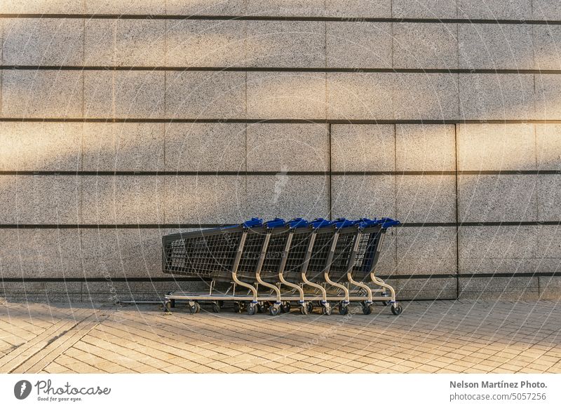 Row of Shopping Carts on the street shopping cart nobody grocery market store row urban in a row metal retail convenience background container line order