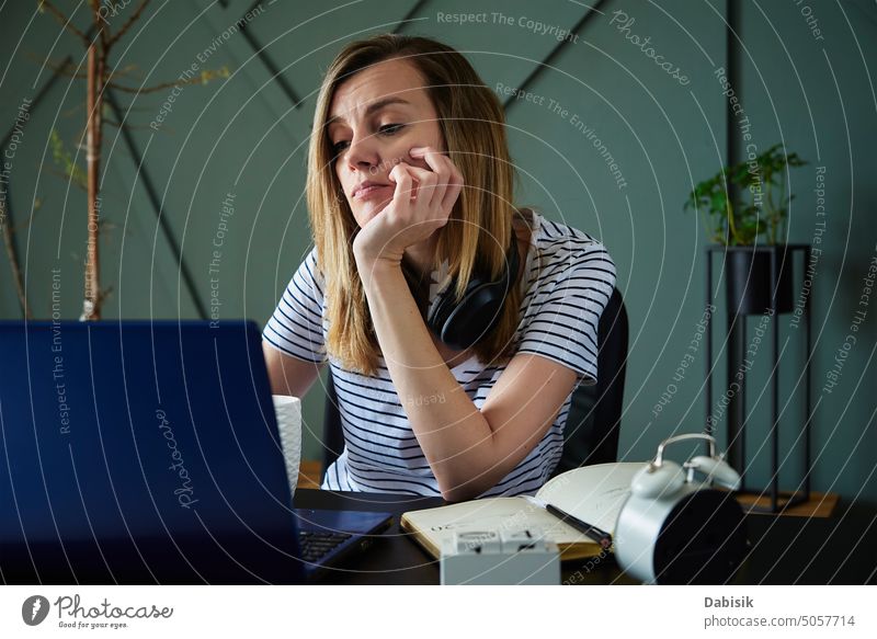 Exhausted woman at home office workplace using laptop exhausted remote work overwork freelancer employed work from home education computer concentrate device