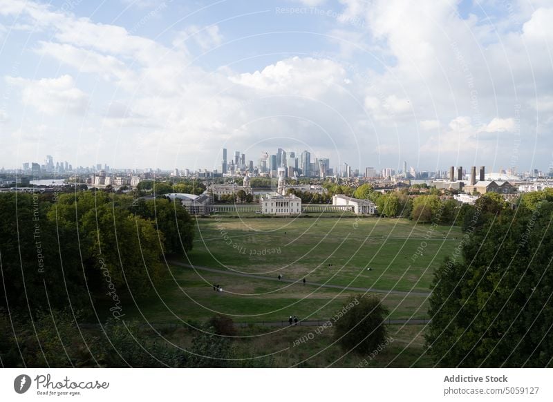 Field near city on cloudy day field building blue sky skyscraper architecture landscape summer historic london united kingdom uk england greenwich