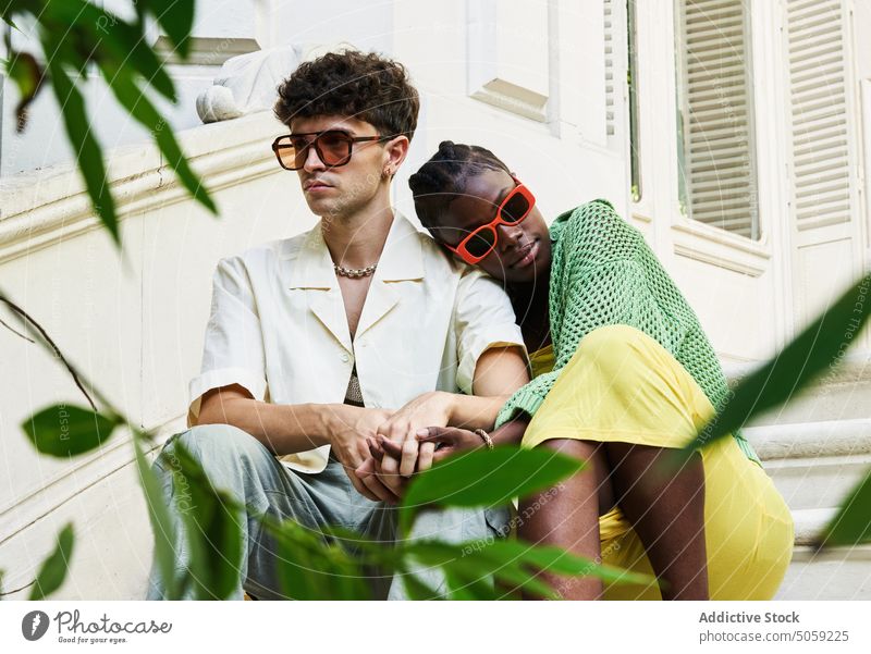 Loving diverse couple sitting on stairs near building relationship fondness affection bonding romantic soulmate spend time style together step love staircase