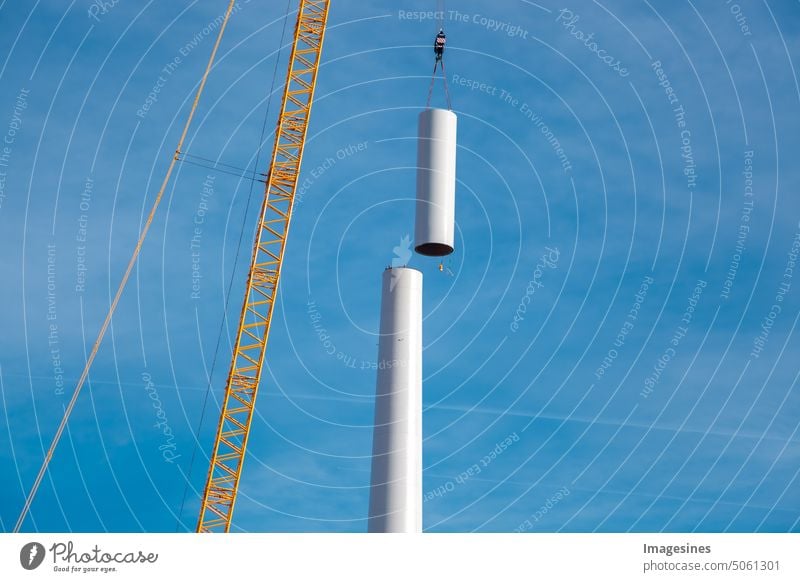 Erection and assembly of a wind turbine by crane. Construction work on the wind turbine at the Wörrstadt wind farm, Germany. Energy crisis concept, wind turbine construction