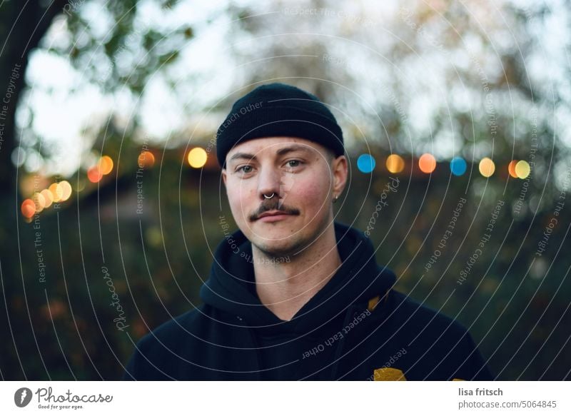 MAN - GRIN - LIGHTS Man 25-29 years Adults Colour photo Exterior shot 20s mustache Cap Hipster Grinning Nasal piercing septum Fairy lights Wait Life Lifestyle