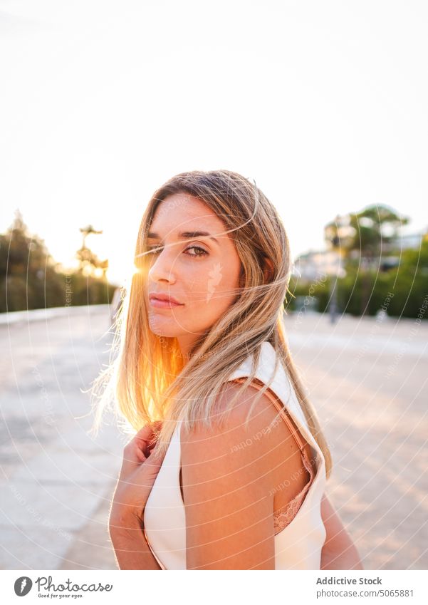 Female standing in park during sunset woman weekend summer evening appearance female young sunshine blond dusk twilight sundown carefree personality style