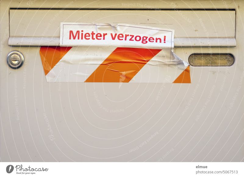 The mail slot of a light gray metal mailbox is taped shut with red and white barrier tape and marked with a note - Tenant spoiled ! - provided Tenant moved