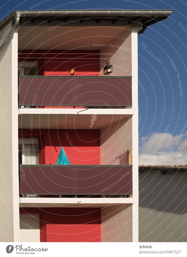 Color contrast red and blue balconies and parasol Balcony Sunshade Closed colour contrast Red Blue Apartment Building detail dwell sunshine Sky downspout Eaves