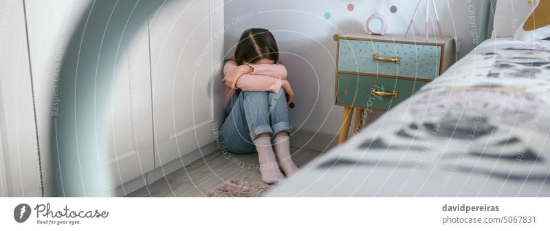 Unrecognizable girl crying on the floor in her bedroom unrecognizable little sad depressed sitting sadness problem mental disorder mental illness banner web