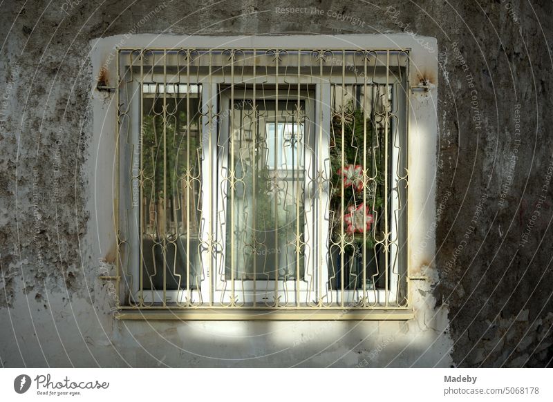 Barred white window in an old dilapidated facade in the sunshine in the old town of Safranbolu in Karabük province, Turkey Window Grating latticed Facade