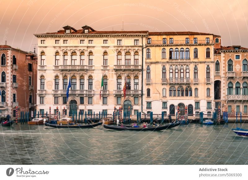 Gondolas and historic building at sunset gondola canal tourist sky evening water old venice italy palazzo ferro fini float vessel dusk coast boat tradition aged