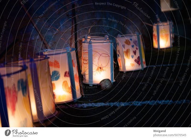 Colorfully lit paper lanterns for St. Martin's procession hung in a row along stairs leading up dark night lantern light Paper lantern Paper lanterns DIY