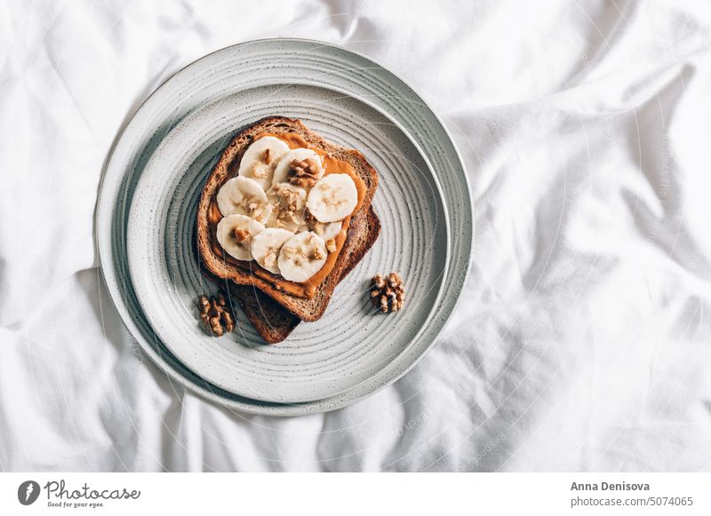 Healthy open sandwich with peanut butter healthy bread banana snack breakfast in bed almond cashew cat kitten wholegrain bread appetizer rye tasty toast home