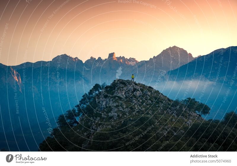 Unrecognizable traveler standing on mountain peak valley landscape scenery sunset nature fog highland asturias sundown tourist picturesque mist tourism evening