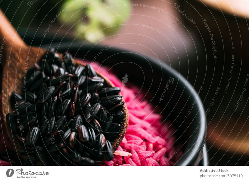 Assorted rice in bowls near eucalyptus twigs assorted natural ingredient table fresh organic vegetarian nutrition composition white black pink diet raw