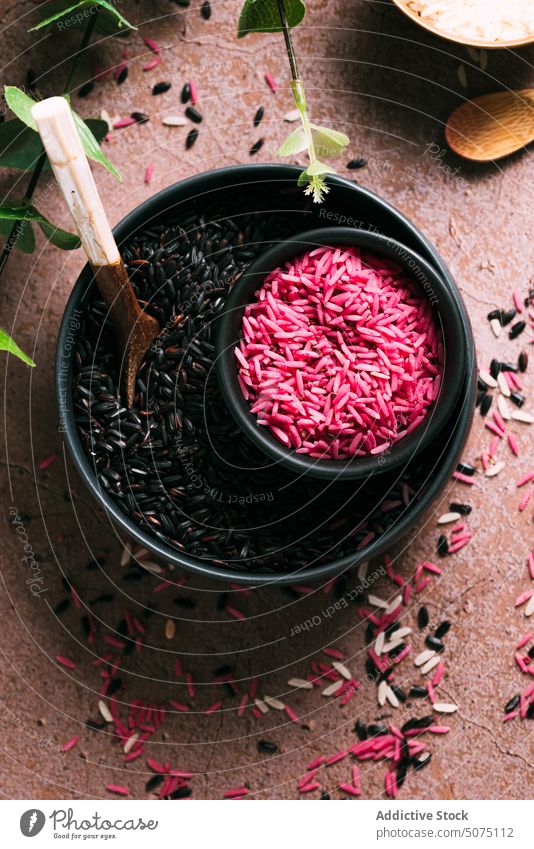 Assorted rice in bowls near eucalyptus twigs assorted natural ingredient table fresh organic vegetarian nutrition composition white black pink diet raw